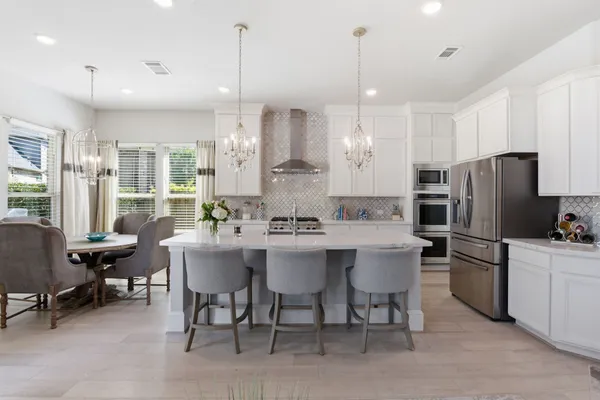 a kitchen with stainless steel appliances a stove microwave and refrigerator