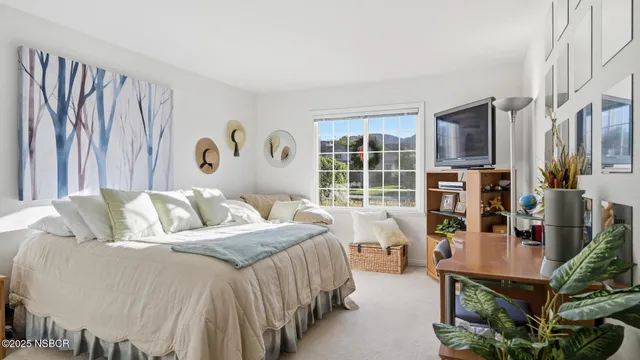 a bedroom with a bed furniture and a large window