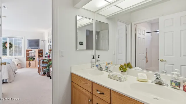 a en suite bathroom with double sink and a mirror