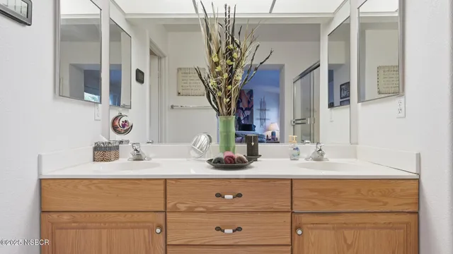 a bathroom with a two sinks a vanity and a mirror