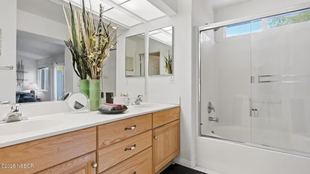 a bathroom with a tub sink and mirror