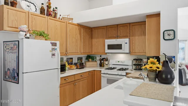 a kitchen with stainless steel appliances a refrigerator sink and cabinets