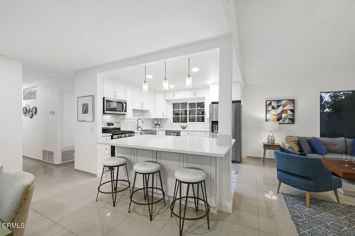 10842 Owens Place Tujunga, CA 91042 - Photo 14 of 68 a kitchen with stainless steel appliances kitchen island granite countertop a sink and cabinets