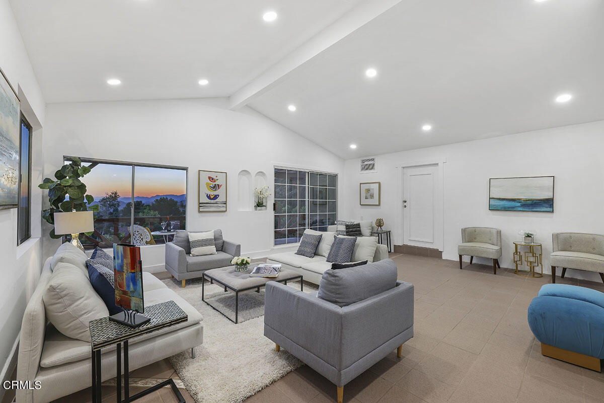 10842 Owens Place Tujunga, CA 91042 - Photo 22 of 68 a living room with furniture and a floor to ceiling window