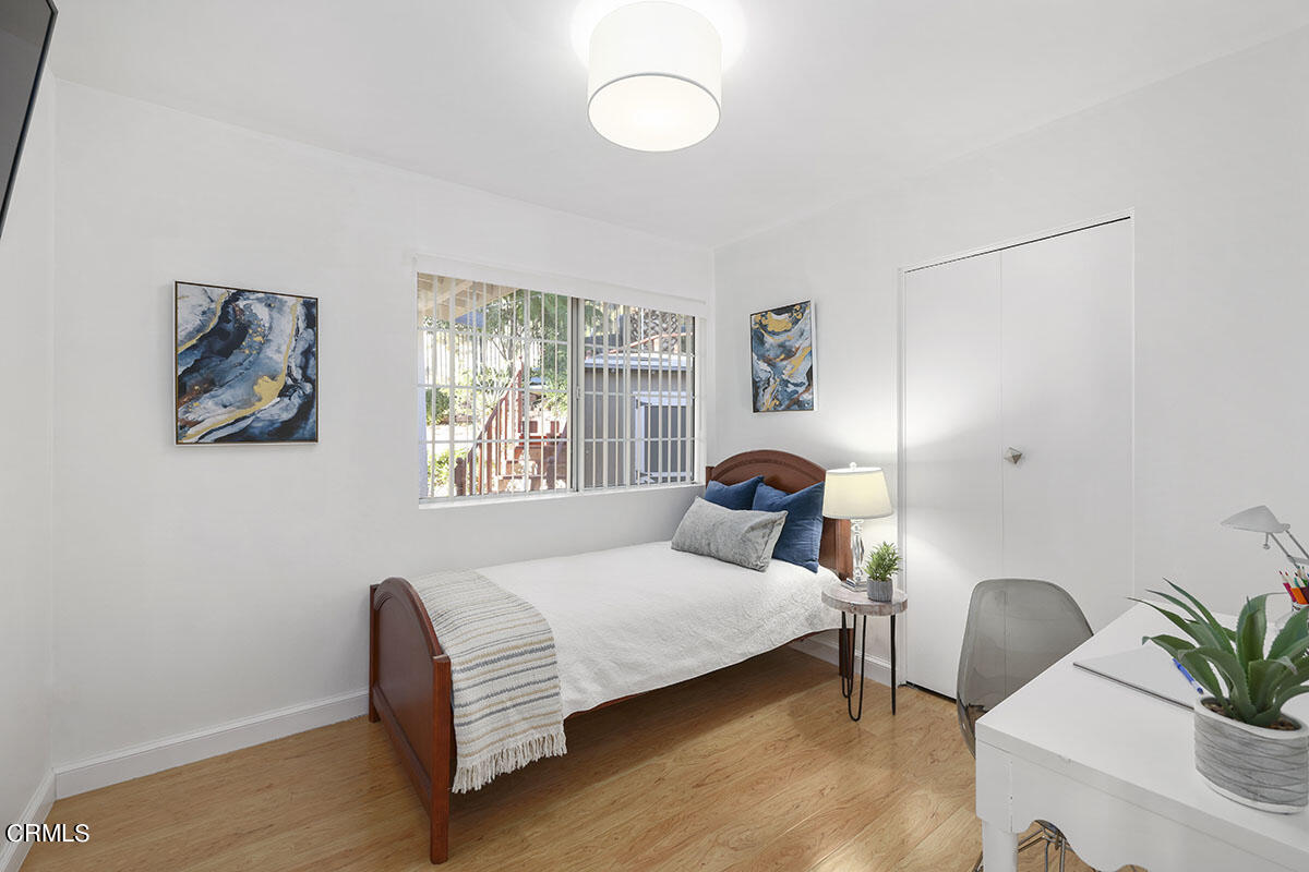 10842 Owens Place Tujunga, CA 91042 - Photo 29 of 68 a bedroom with a bed and a chair