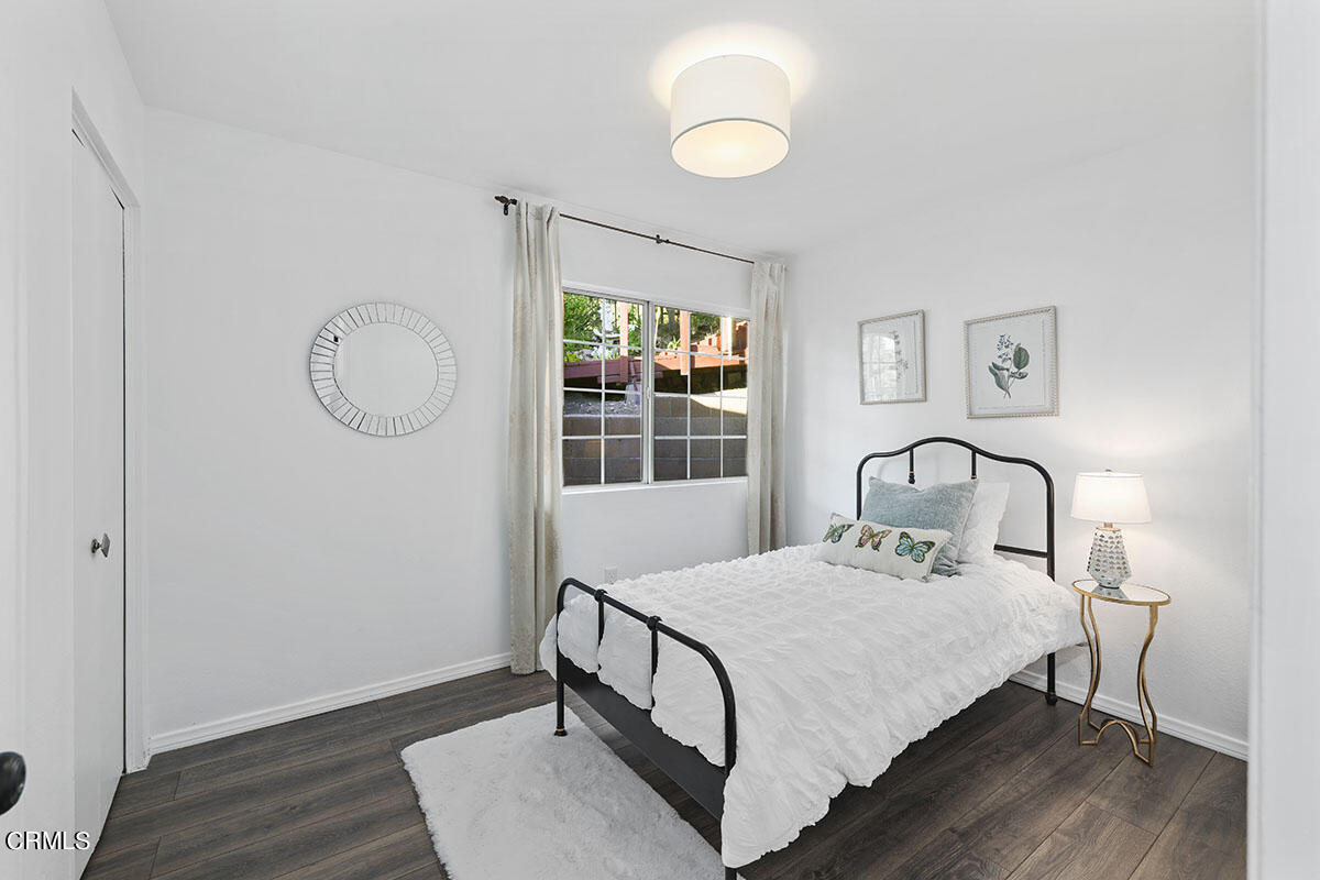 10842 Owens Place Tujunga, CA 91042 - Photo 31 of 68 a bedroom with a bed a window and potted plant