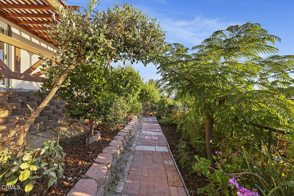 10842 Owens Place Tujunga, CA 91042 - Photo 43 of 68 a view of a pathway both side of white house