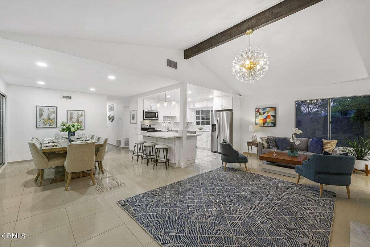 10842 Owens Place Tujunga, CA 91042 - Photo 5 of 68 a living room with furniture a dining table and a chandelier