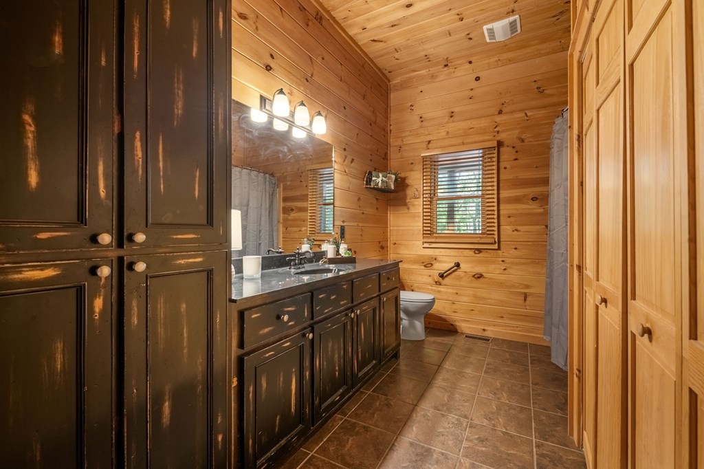 52 Whispering Lane Blue Ridge, GA 30513 - Photo 14 of 35 a bathroom with a double vanity sink and mirror with shower