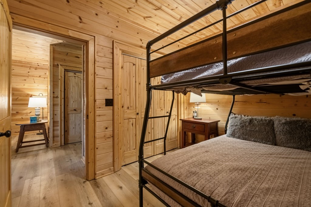 52 Whispering Lane Blue Ridge, GA 30513 - Photo 23 of 35 a bedroom with a bed and wooden floor