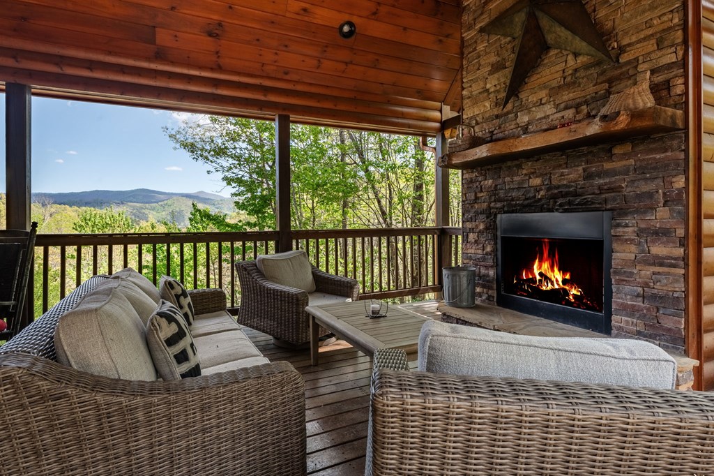52 Whispering Lane Blue Ridge, GA 30513 - Photo 3 of 35 a living room with furniture a fireplace and a floor to ceiling window