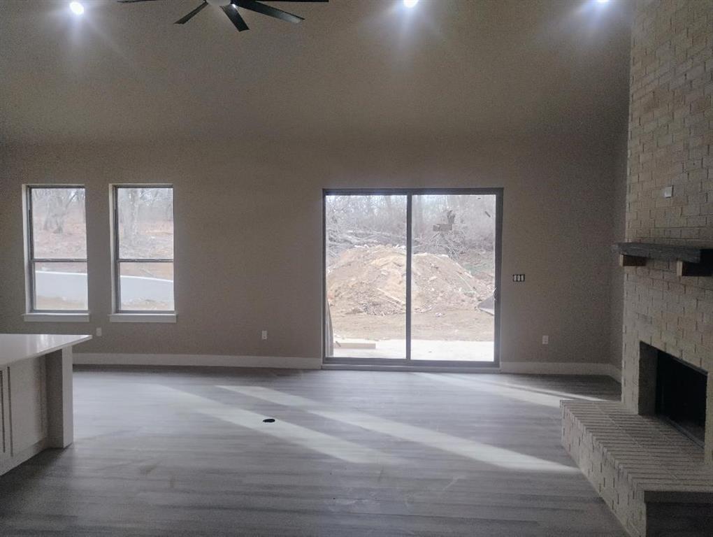 146 Hauser Place Runaway Bay, TX 76426 - Photo 12 of 15 an empty room with windows and fireplace