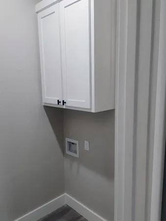 a view of storage and utility room with a window