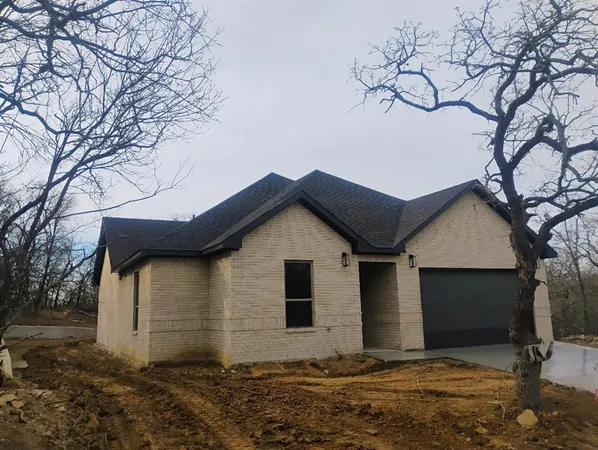 a house that has a tree in front of it