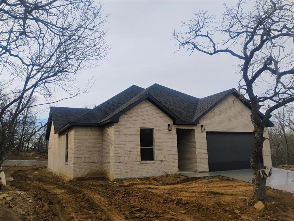 146 Hauser Place Runaway Bay, TX 76426 - Photo 2 of 15 a house that has a tree in front of it