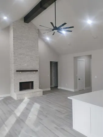 a view of an empty room with a fireplace