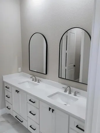 a bathroom with a double vanity sink and a mirror
