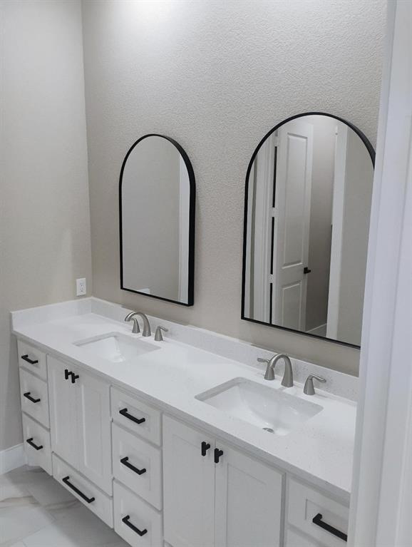146 Hauser Place Runaway Bay, TX 76426 - Photo 6 of 15 a bathroom with a double vanity sink and a mirror