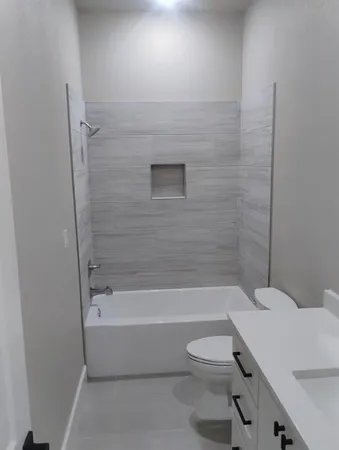 a bathroom with a toilet and a bath tub