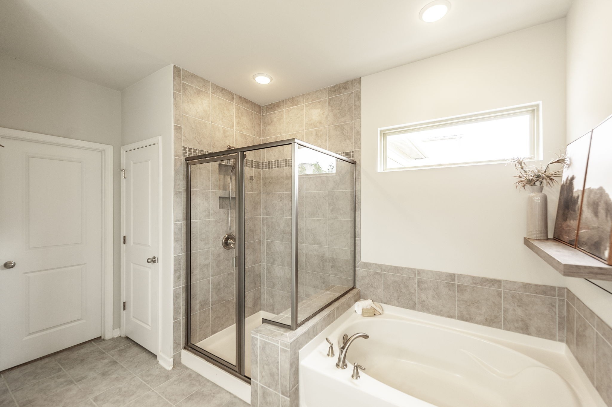 1095 Brixworth Drive Spring Hill, TN 37174 - Photo 23 of 49 a bathroom with a bathtub and a shower