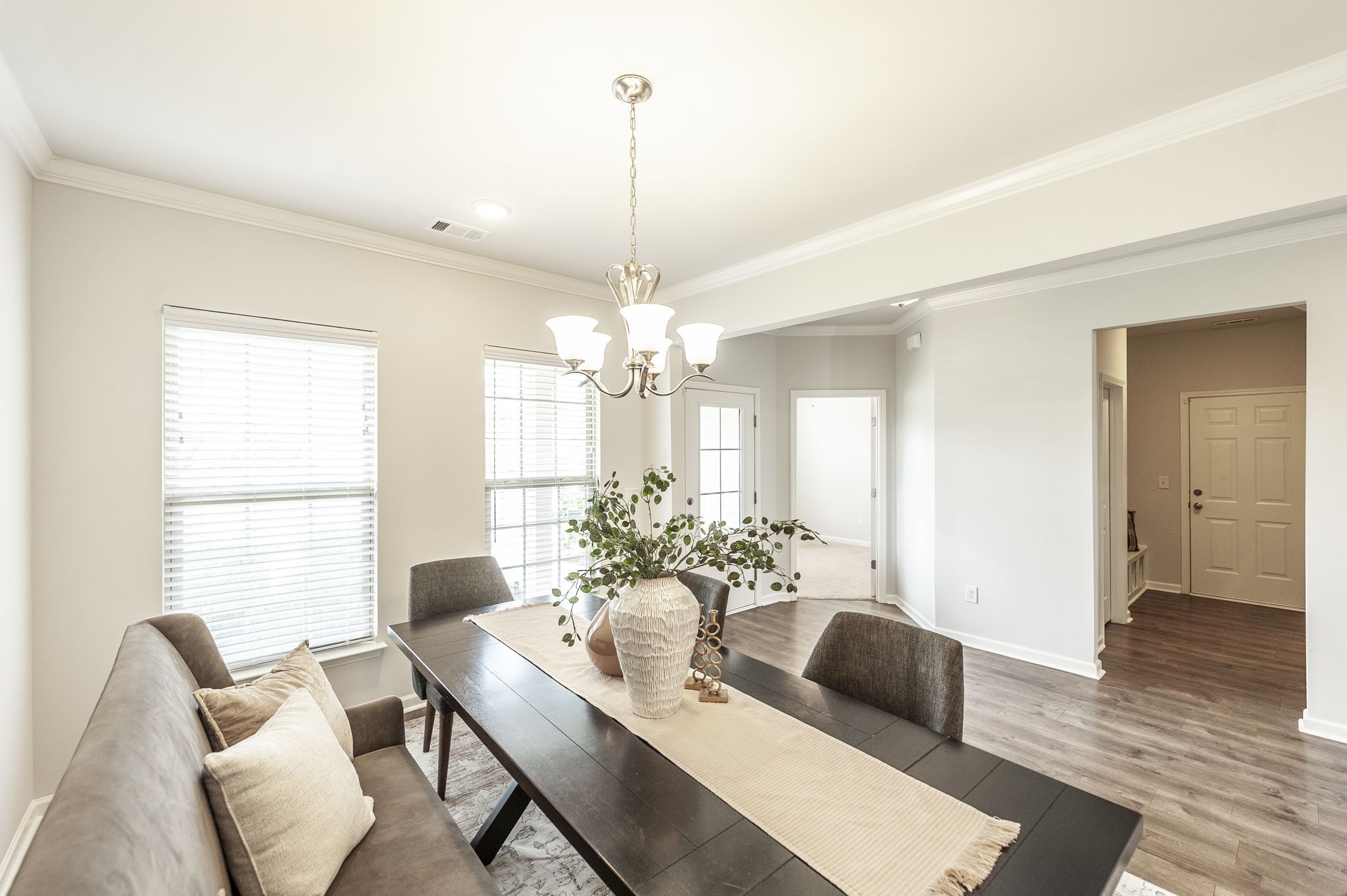 1095 Brixworth Drive Spring Hill, TN 37174 - Photo 3 of 49 a dining room with furniture a chandelier and wooden floor