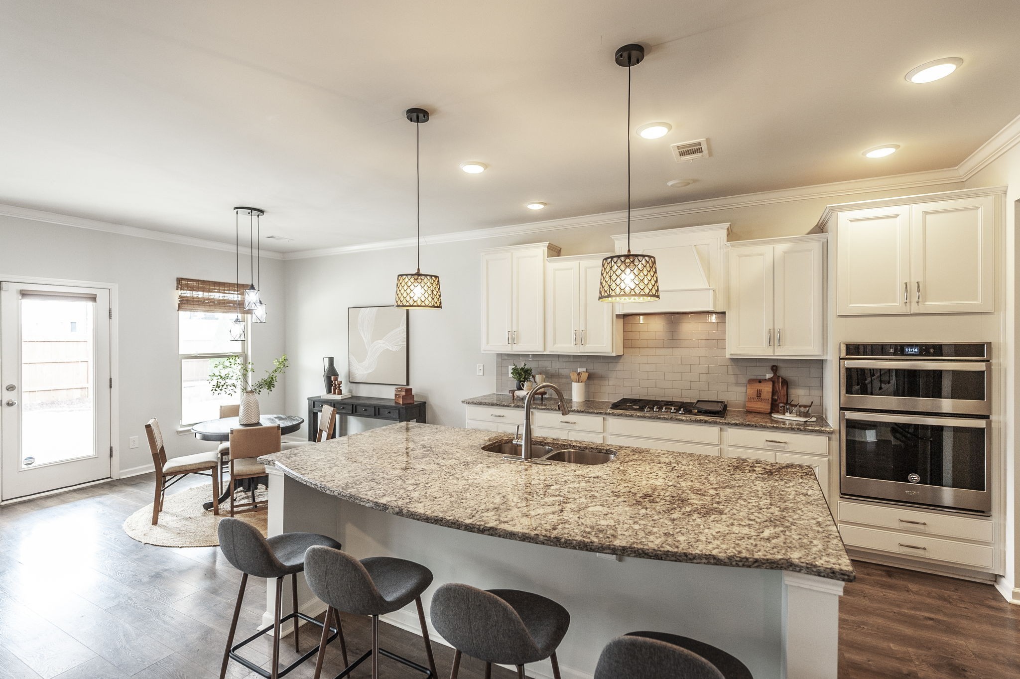 1095 Brixworth Drive Spring Hill, TN 37174 - Photo 6 of 49 a kitchen with granite countertop kitchen island stainless steel appliances and a table
