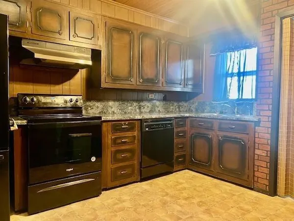 a kitchen with stainless steel appliances granite countertop a stove and a microwave