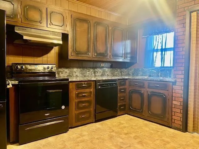 a kitchen with stainless steel appliances granite countertop a stove and a microwave