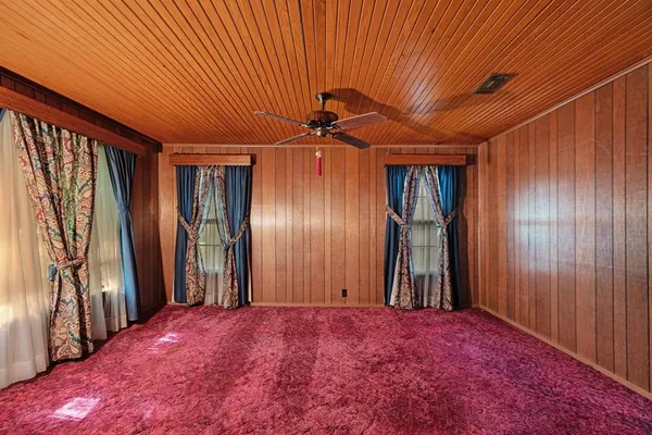 an empty room with closet and entryway