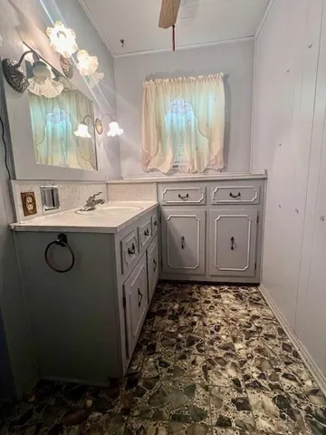 a bathroom with a sink a vanity and a mirror