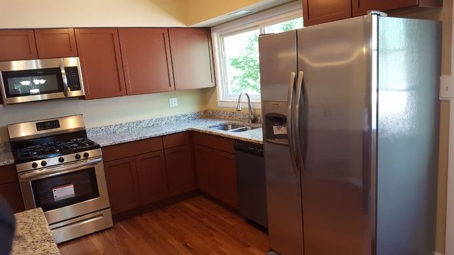 457 Galahad Road Bolingbrook, IL 60440 - Photo 4 of 14 a kitchen with a refrigerator stove and microwave