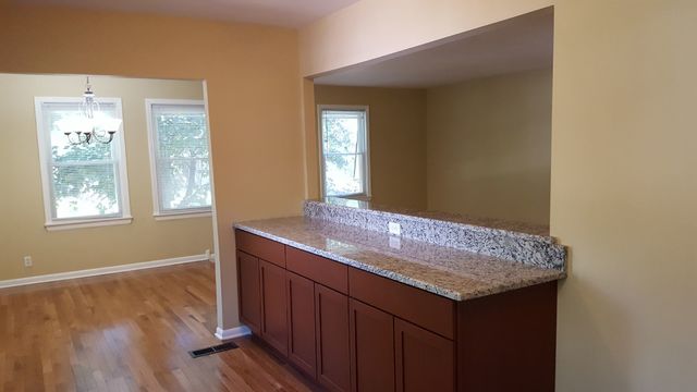 457 Galahad Road Bolingbrook, IL 60440 - Photo 6 of 14 a bathroom with a granite countertop sink and wooden floor