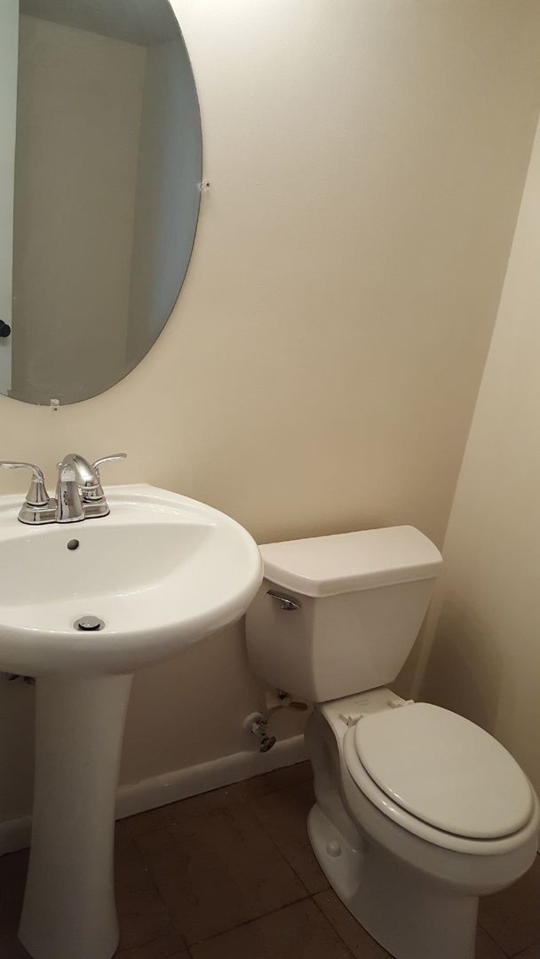 457 Galahad Road Bolingbrook, IL 60440 - Photo 8 of 14 a white toilet sitting next to a bathroom sink