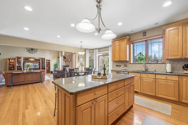 a large white kitchen with a large window