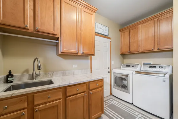 a kitchen with stainless steel appliances granite countertop a sink a stove and cabinets