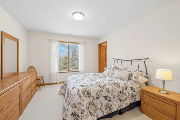 a bedroom with a bed and a lamp with window