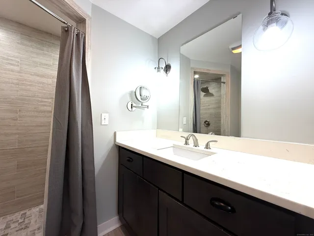 a white toilet sitting next to a bathroom sink