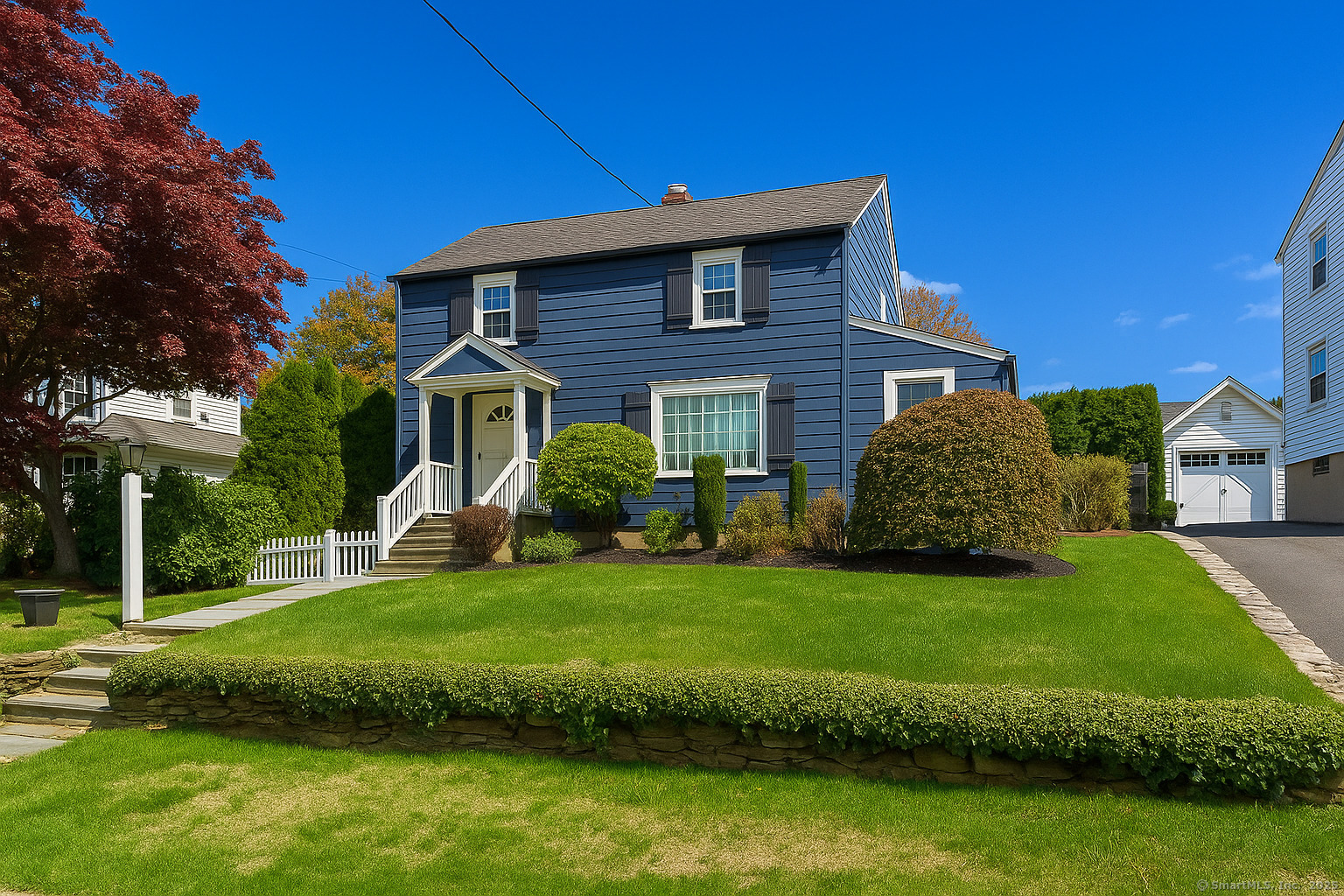 467 Wilson Street Fairfield, CT 06825 - Photo 2 of 18 a front view of a house with a garden