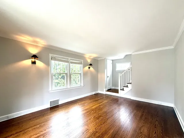 a view of a livingroom with wooden floor and a window