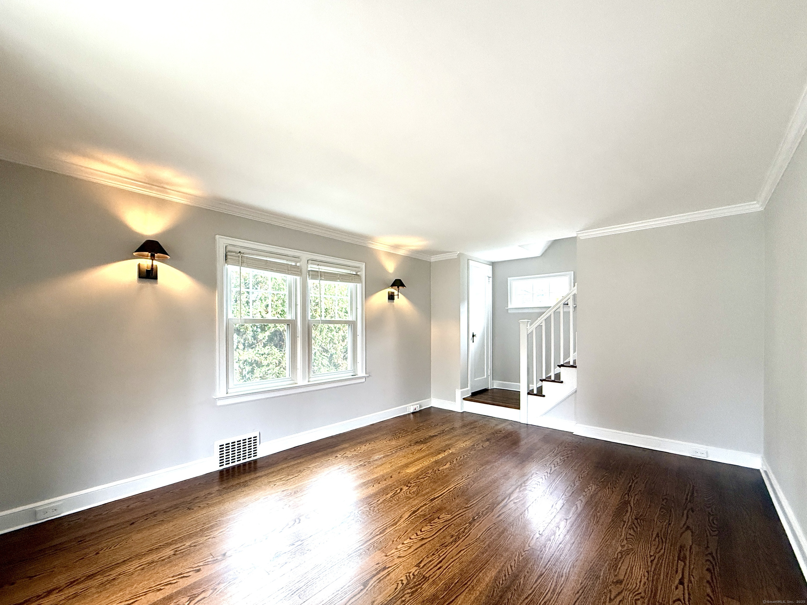 467 Wilson Street Fairfield, CT 06825 - Photo 4 of 18 a view of a livingroom with wooden floor and a window