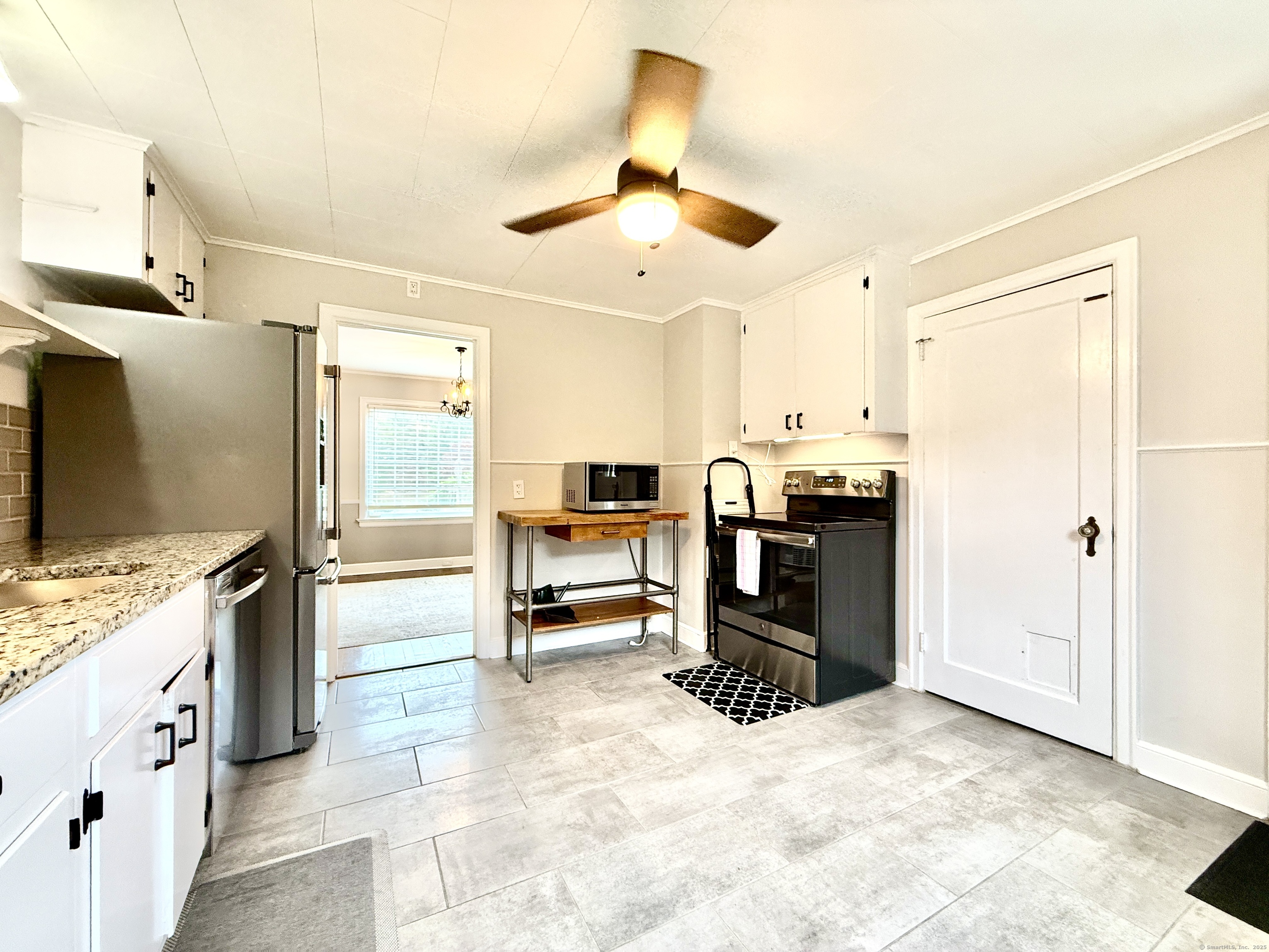 467 Wilson Street Fairfield, CT 06825 - Photo 9 of 18 a kitchen with stainless steel appliances kitchen island granite countertop a refrigerator and a stove top oven