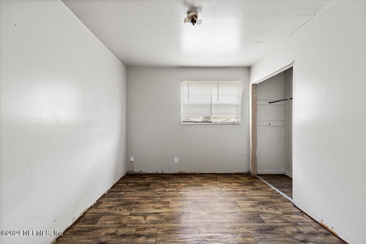 8988 Castle Boulevard Jacksonville, FL 32208 - Photo 12 of 28 an empty room with a empty space and windows