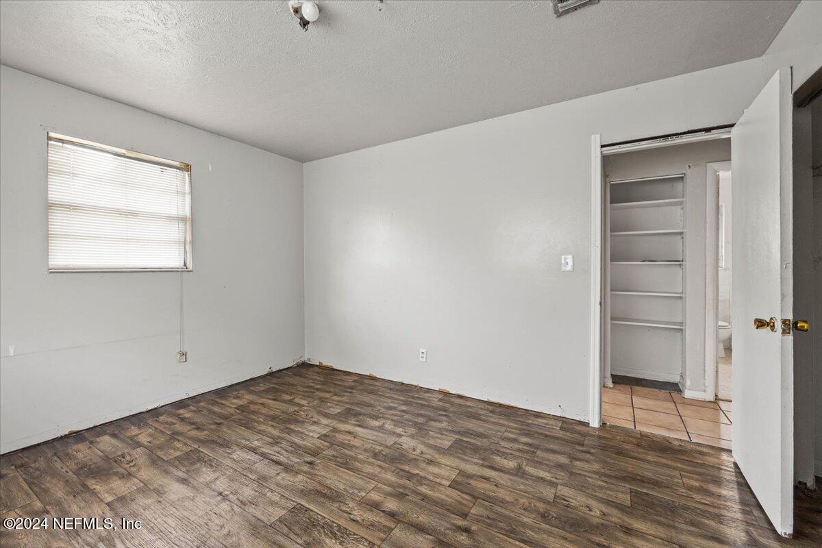 8988 Castle Boulevard Jacksonville, FL 32208 - Photo 16 of 28 a view of empty room with wooden floor