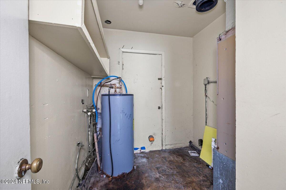 8988 Castle Boulevard Jacksonville, FL 32208 - Photo 24 of 28 a view of hallway with stairs and wooden floor