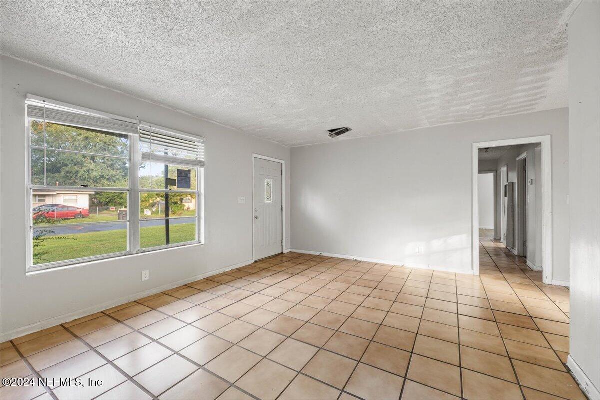 8988 Castle Boulevard Jacksonville, FL 32208 - Photo 7 of 28 a view of an empty room and window