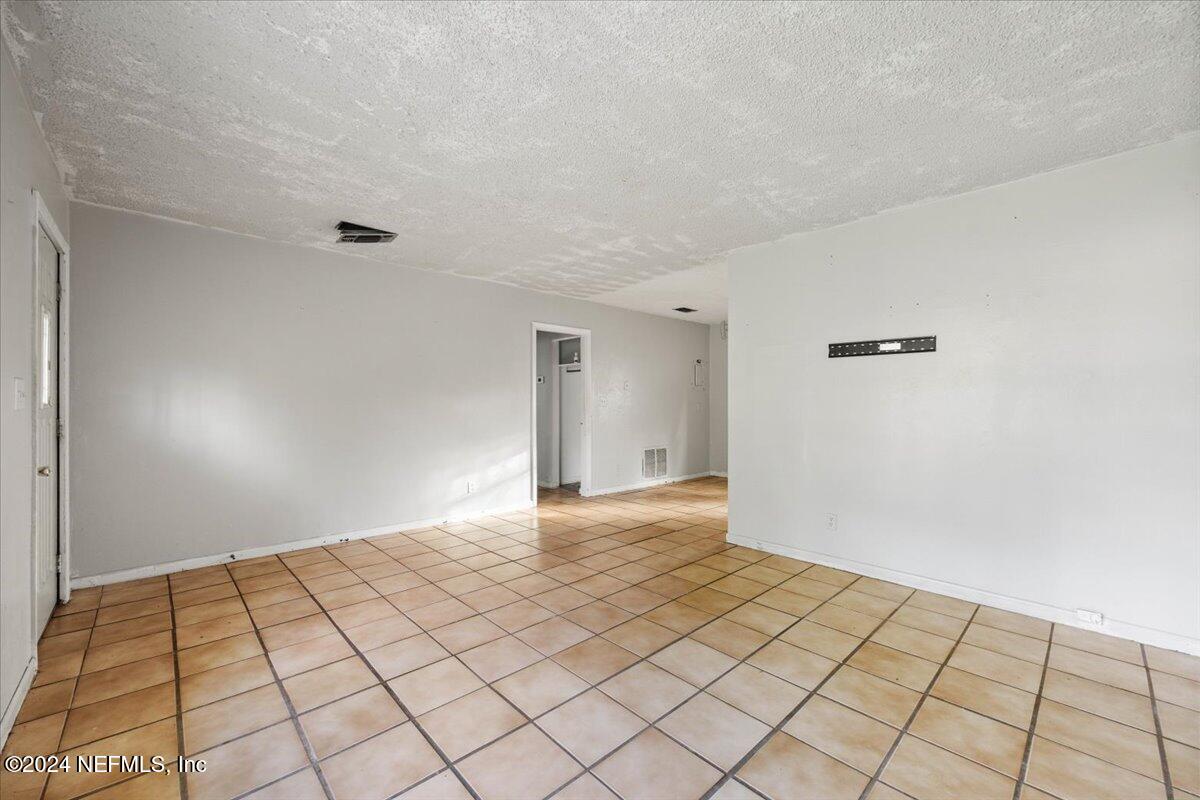 8988 Castle Boulevard Jacksonville, FL 32208 - Photo 8 of 28 a view of an empty room