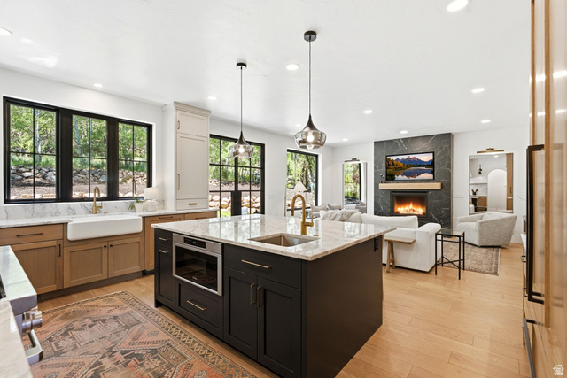 3027 Homestead Road Park City, UT 84098 - Photo 6 of 62 Open-concept kitchen featuring a large central island with integrated microwave, gold-finish faucet, and granite countertop