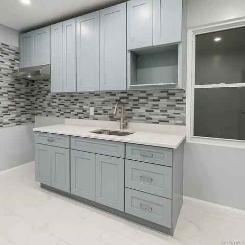 a kitchen with granite countertop white cabinets and stainless steel appliances