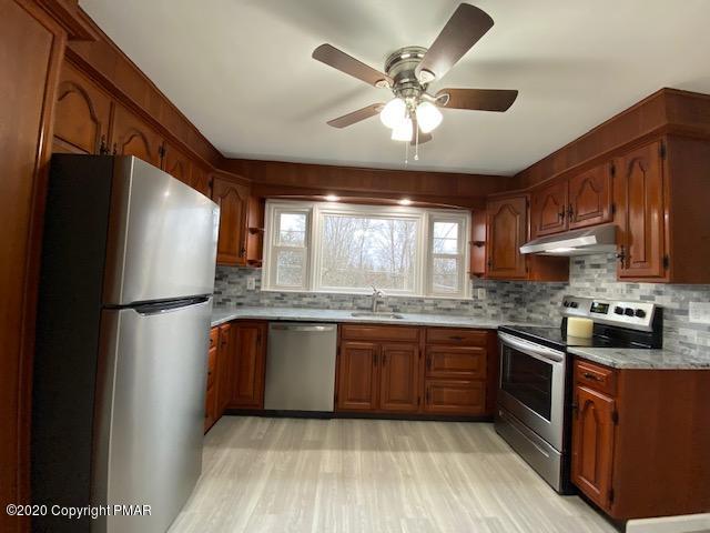 7522 Old Coach Road Stroudsburg, PA 18360 - Photo 23 of 68 a kitchen with stainless steel appliances granite countertop a refrigerator a sink dishwasher a stove and a refrigerator