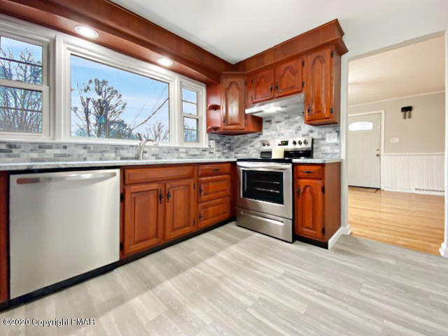 7522 Old Coach Road Stroudsburg, PA 18360 - Photo 25 of 68 a kitchen with stainless steel appliances granite countertop a stove a sink and a microwave